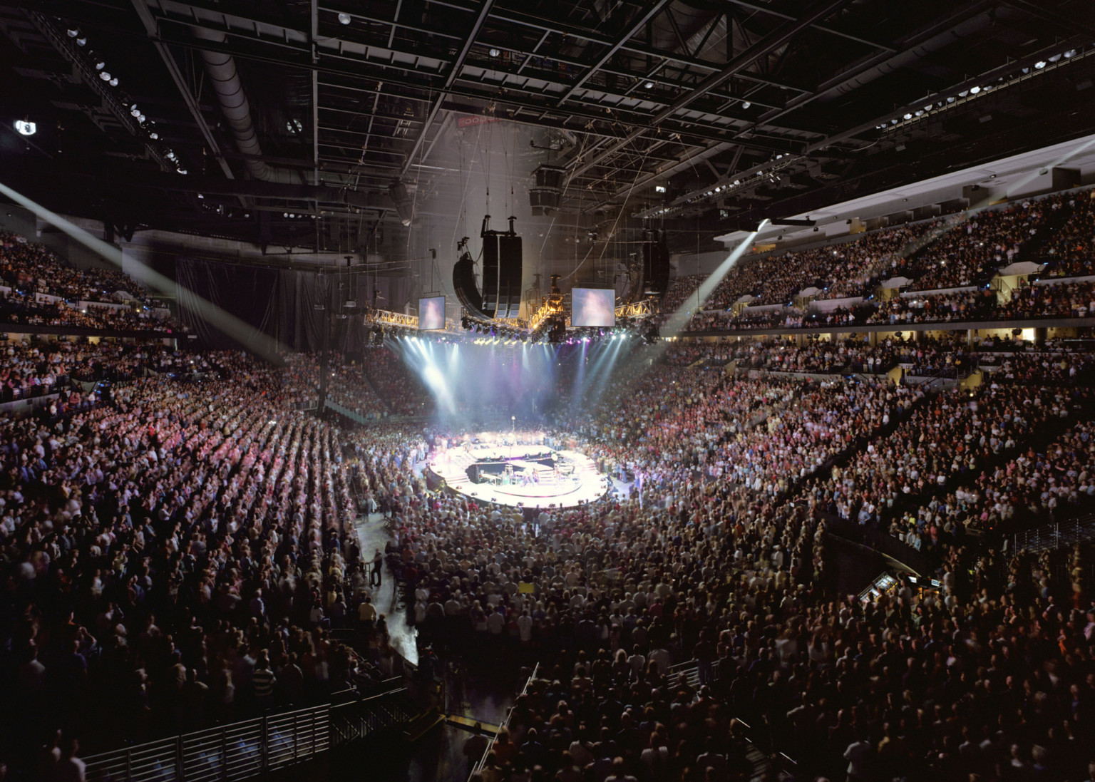 Chi Health Center Omaha interior event and sporting venue. Stadium seating filled during a concert performance with lighting above