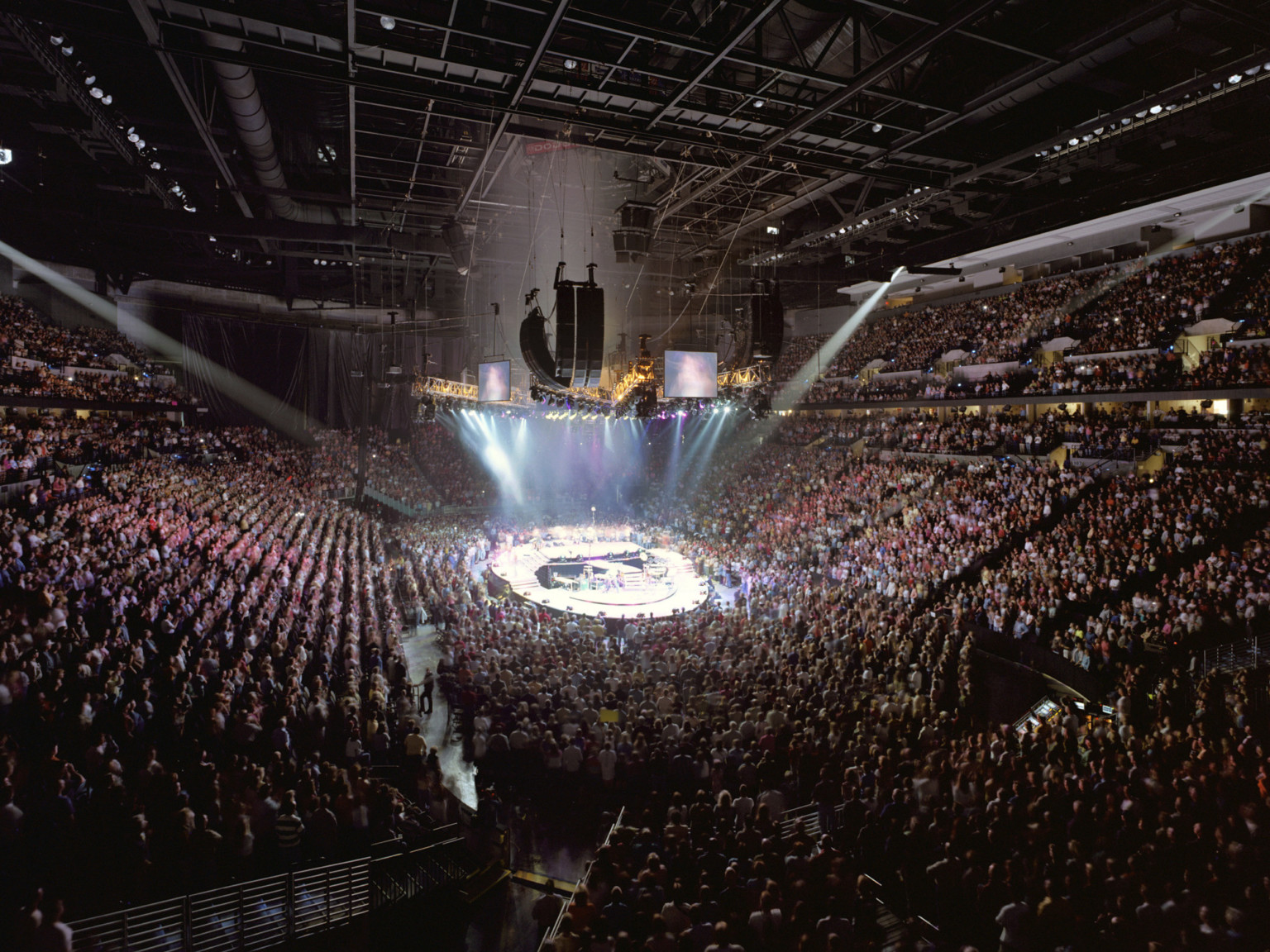 Chi Health Center Omaha interior event and sporting venue. Stadium seating filled during a concert performance with lighting above Chi Health Center Omaha interior event and sporting venue. Stadium seating filled during a concert performance with lighting above