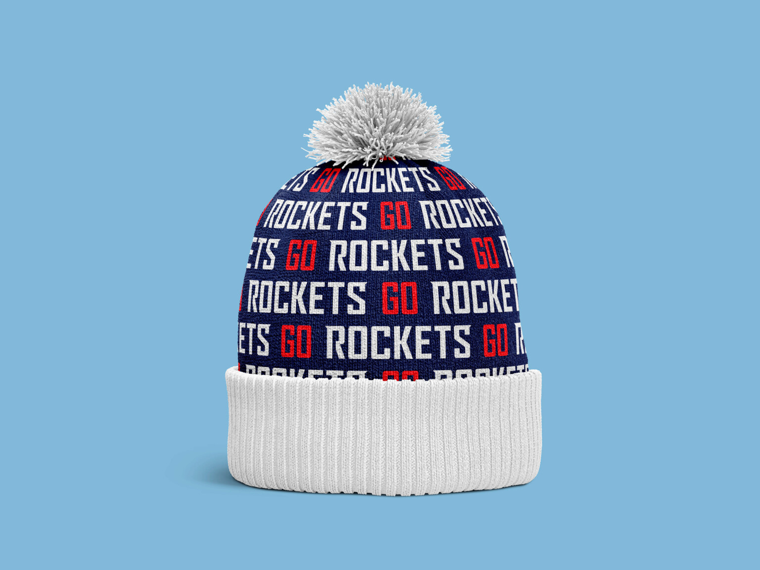 Beanie hat with pompom, hat has go rockets written repeatedly in red and white on a blue background