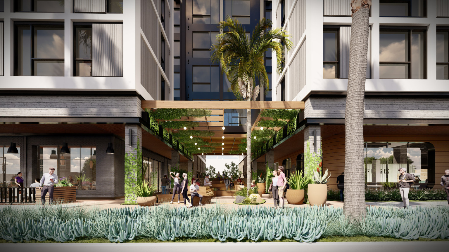 shaded pedestrian seating and walkways at the foot of a building development with palm trees and living ground cover