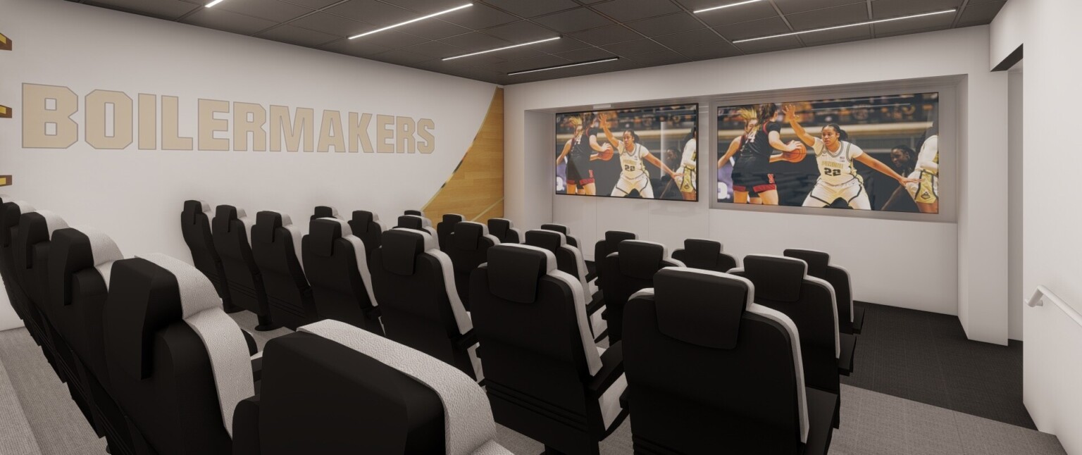 Small auditorium with comfortable grey stadium style seats looking to large screen. Wood and white mural on far wall with Boilermakers sign