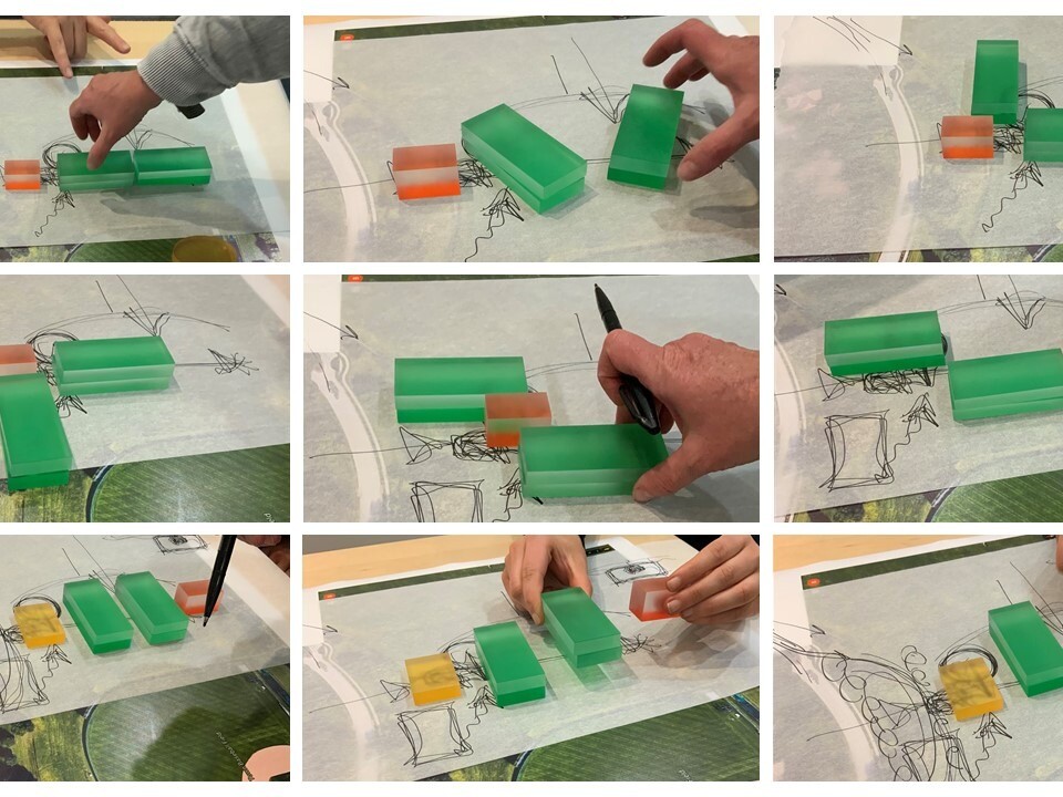 2 people stacking blocks in different parts of a rendering to simulate different potential design solutions