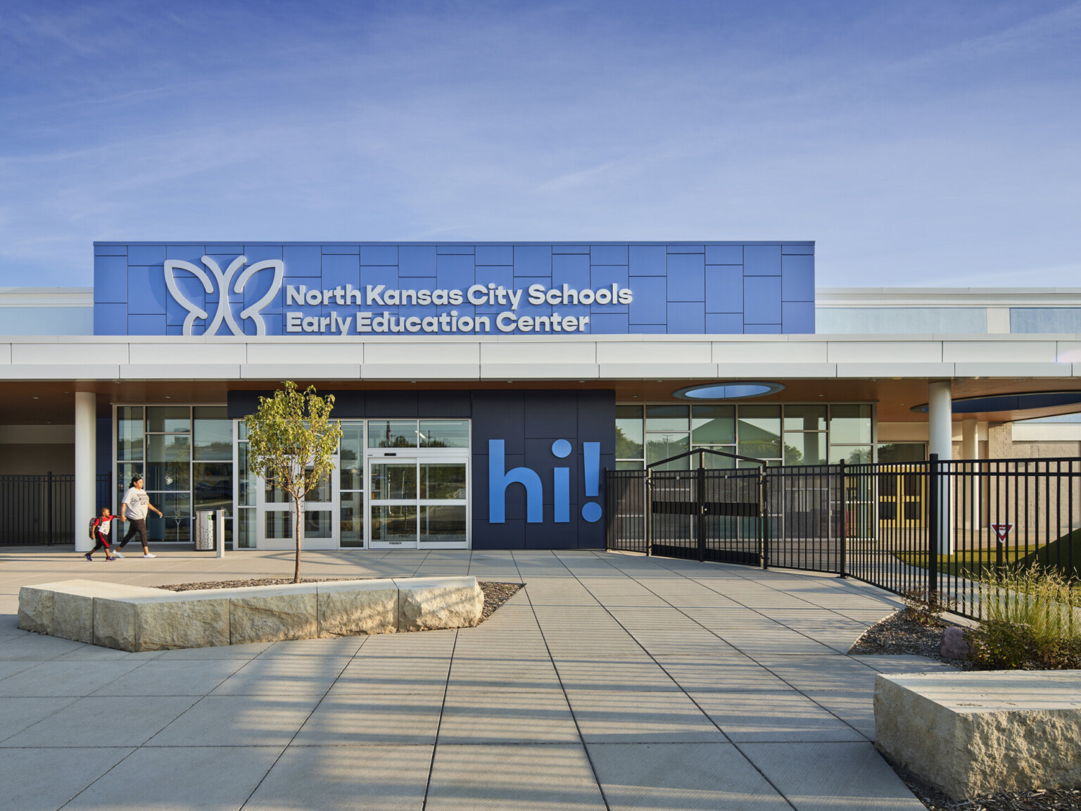 North Kansas City School Early Education Center exterior, a two tone blue facade, large "Hi!" mural by entry