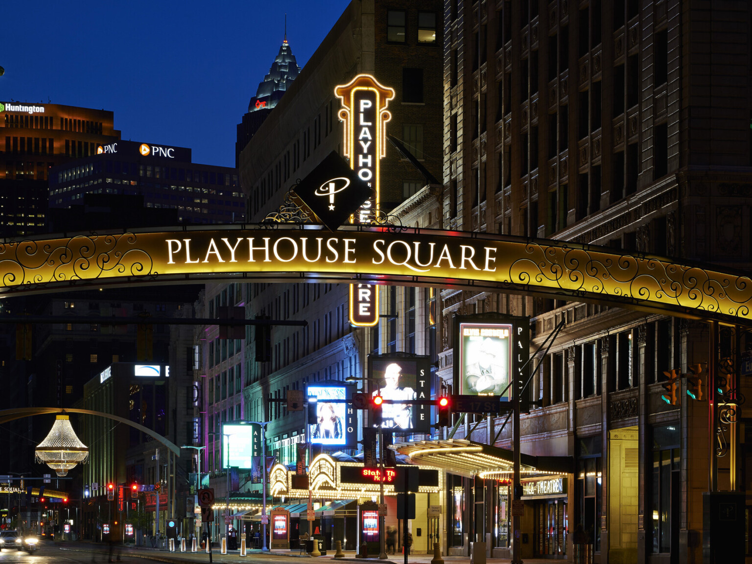 Cleveland's Playhouse Square Theater District after dark, restored vintage neon lighting signage, well-lit pedestrian-friendly walkways and beautifully restored 1920s architecture