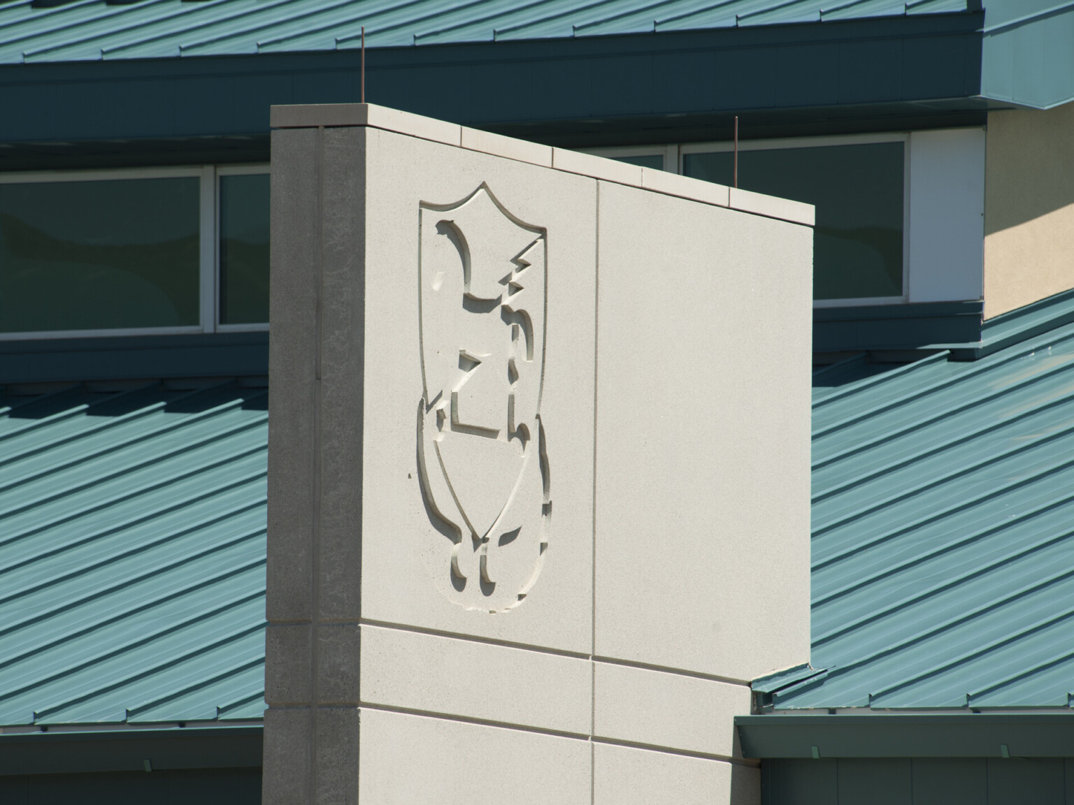 Fort Carson 10th Group SOF Battalion Operations Complex roof and grey cement accent facade panel with logo